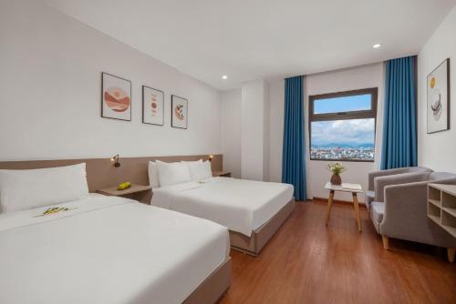 Ένα ή περισσότερα κρεβάτια σε δωμάτιο στο ELC Da Nang Hotel