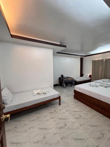 Katil atau katil-katil dalam bilik di MANANQUIL TRAVEL LODGE