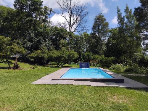 a swimming pool in the middle of a yard at Benmore Lodge in Ferrby