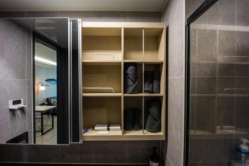a closet with a mirror and some shoes in it at Gwangan antique summer accommodations the ocean in Busan