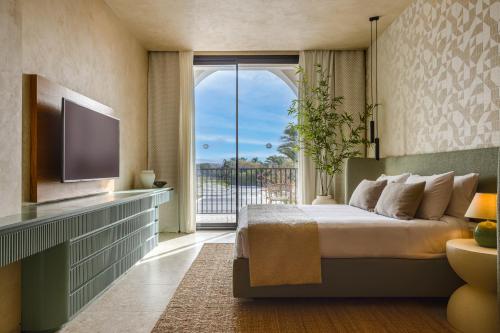 a bedroom with a bed and a large window at Desert Rose Resort in Hurghada