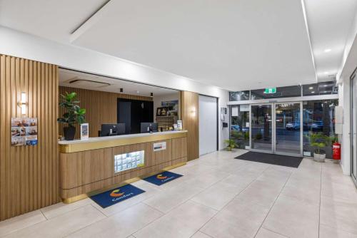 an office lobby with a reception desk in a building at Comfort Inn Regal Park in Adelaide