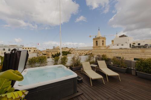 a hot tub on the roof of a building at Casa Reale Boutique Hotel in Valletta