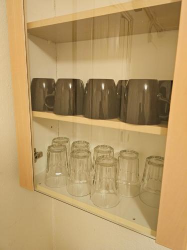 a row of glass mason jars sitting on a shelf at Dream Sleep Inn in Aalborg
