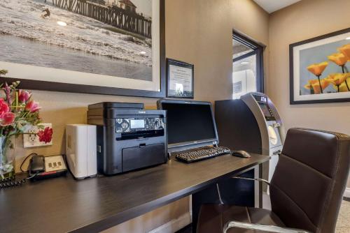 an office with a desk with a computer on it at Comfort Inn & Suites Huntington Beach in Huntington Beach