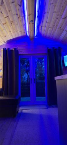 a room with blue lights in a room with doors at Kintarvie Hideaway in Balallan