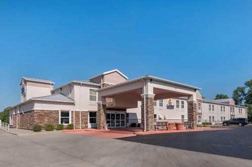 a hotel with a parking lot in front of it at Comfort Inn & Suites Junction City - near Fort Riley in Junction City
