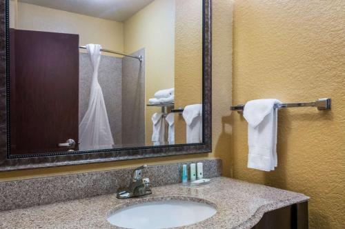 a bathroom with a sink and a mirror at Quality Inn & Suites Slidell in Slidell