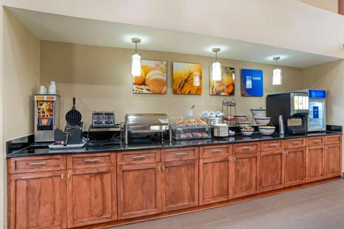 a restaurant counter with a bunch of food at Comfort Inn University Area in Baton Rouge