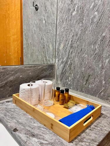 a wooden tray with toiletries on a counter in a bathroom at Nazareth Cânion in Buriti dos Montes