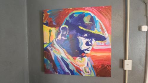 a painting of a man on a wall at Huge 4-Bedroom Historic Home & Game Room in Goldsboro