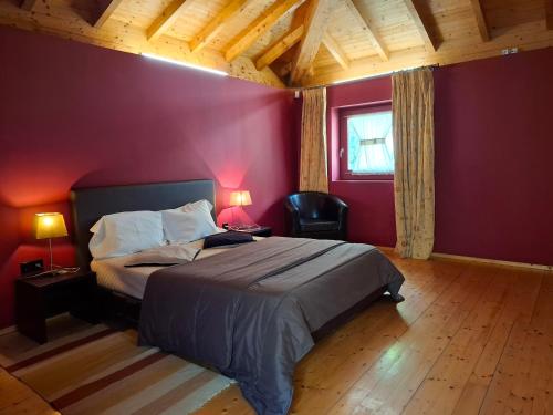 a bedroom with a bed and a red wall at House 1 in Fafe