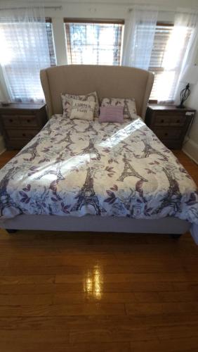a bedroom with a bed with a paris bedspread at Huge 4-Bedroom Historic Home & Game Room in Goldsboro