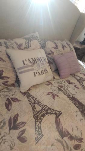 a bed with a comforter with a pillow on it at Huge 4-Bedroom Historic Home & Game Room in Goldsboro