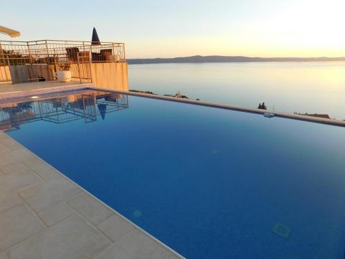 a swimming pool with a view of the water at Villa Lilly in Podgora