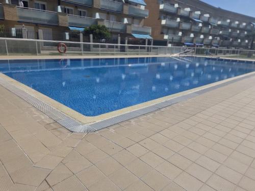 a large swimming pool in front of a building at RELAX-Apt in Benicarló