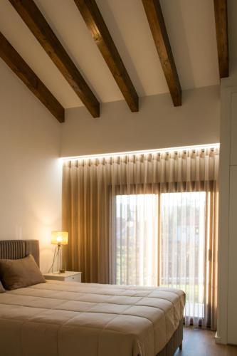 a bedroom with a bed and a large window at Casa Serra De Soajo in Soajo