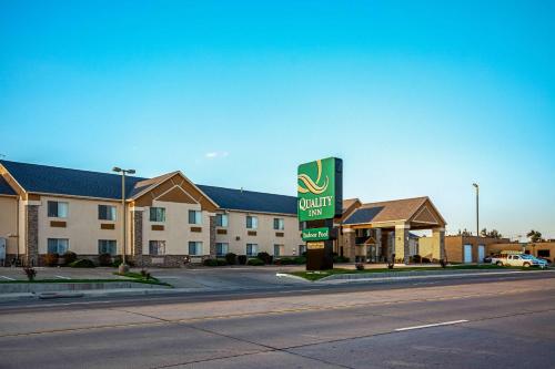 a sign for a hotel on the side of a road at Quality Inn Dodge City in Dodge City