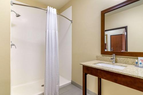 a bathroom with a shower and a sink at Comfort Inn & Suites Salina North in Salina