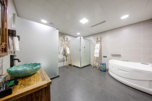 a bathroom with a sink and a refrigerator at 杭州茶香丽舍旅居民宿 in Hangzhou
