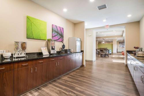a kitchen with wooden cabinets and a counter top at Sleep Inn & Suites Park City-Wichita North in Park City