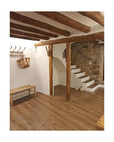 a living room with a wooden floor and stairs at Casa Morel in Morella