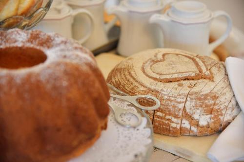 two breads sitting on a table with a pair of scissors at Haus Mariella in Podersdorf am See