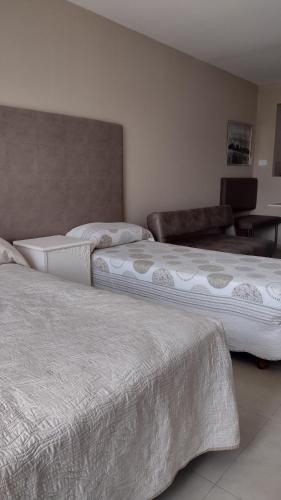 two beds sitting next to each other in a room at Lofts & Suites in Rosario