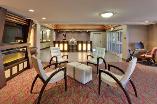 a lobby with chairs and a table and a living room at Country Inn & Suites by Radisson, San Carlos, CA in San Carlos
