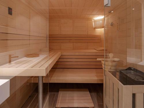 a sauna with a tub and a sink at Mercure Ponta Delgada Azores in Ponta Delgada