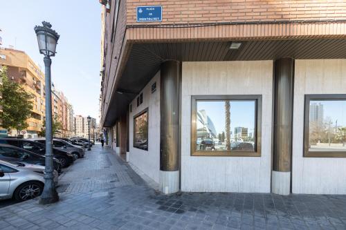 a building on a city street with parked cars at Les Arts Plaza by Concept Flats in Valencia