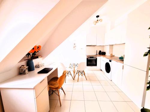 a kitchen with white cabinets and a white tile floor at Bucharest Central EE Apartment in Bucharest