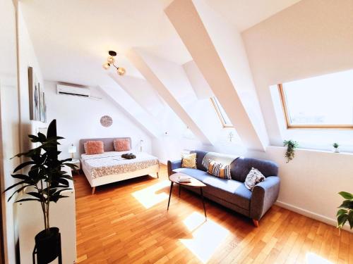 a living room with a couch and a bed at Bucharest Central EE Apartment in Bucharest