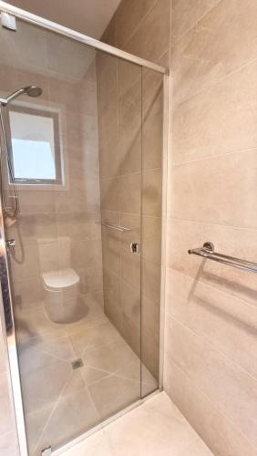a shower with a glass door in a bathroom at Cozy Room with Private Bathroom in Wheelers Hill