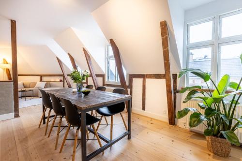 a dining room with a wooden table and chairs at Penthouse in the heart of Copenhagen in Copenhagen