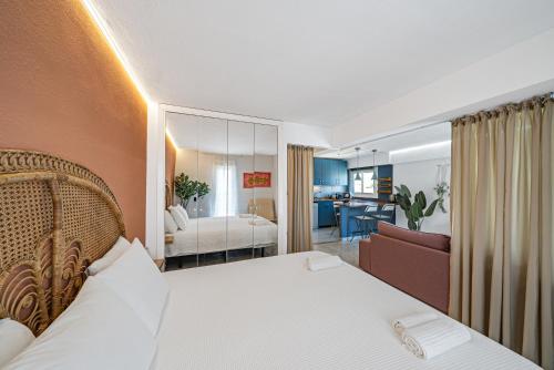 a bedroom with a bed and a living room at Pura Vida King-Size Bed Sea and Mountain view Apartment in Benalmádena
