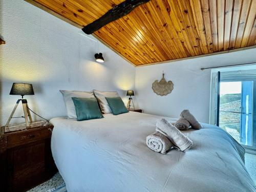 une chambre avec un grand lit avec des serviettes dessus dans l'établissement Maison de vacance familiale Tomlina, Neffies, à Néffiès