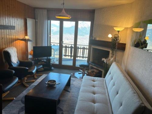 a living room with a couch and a table at Melezes K 021 - SKI & NATURE apartment 6 pers in Veysonnaz