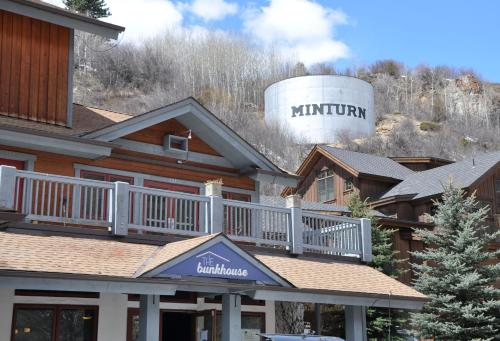 a log home with a water tower on the hill at The Bunkhouse in Minturn