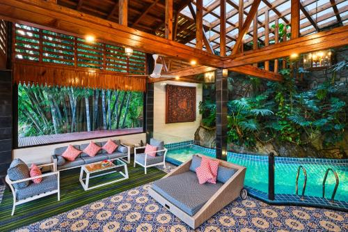 an outdoor patio with a pool and chairs and a swimming pool at Mayfair Spa Resort & Casino in Gangtok