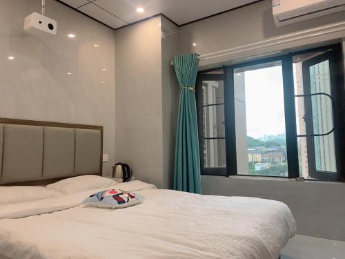 a bedroom with two beds and a window at Space Sharing Station in Guiyang