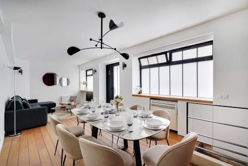 une salle à manger et un salon avec une table et des chaises dans l'établissement Chic apartment - 2BR 6P - Saint-Ambroise, à Paris
