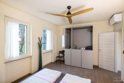 a bedroom with a bed and a ceiling fan at Residence Alesi in Malcesine