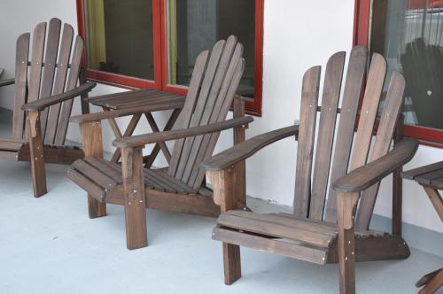 three wooden chairs sitting in front of a window at The Bunkhouse in Minturn