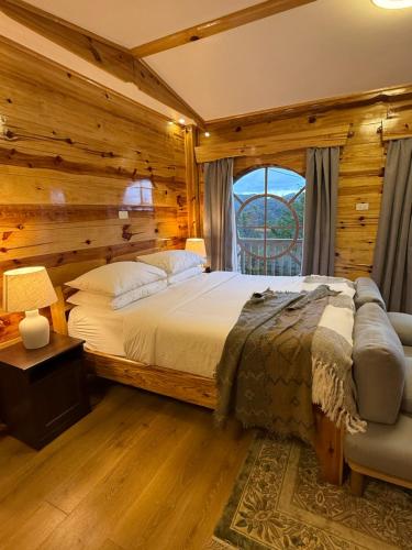 a bedroom with a bed and a window at ELVEN VILLAS of the The Shire in Sagada
