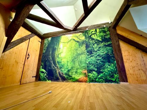 a room with a tree mural on the wall at House-Museum #Medieval unique experience in Tallinn