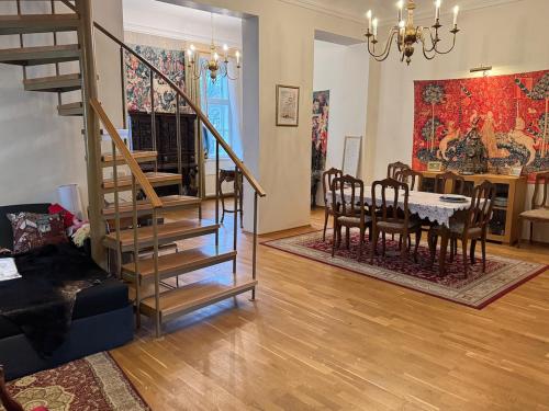 a living room with a staircase and a dining room at House-Museum #Medieval unique experience in Tallinn