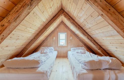 two beds in a room in a attic at Greystone House / Historic / Traditional / Unique in Saltnes