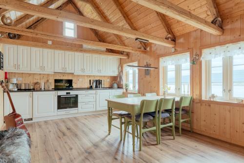 a kitchen with white cabinets and a table and chairs at Greystone House / Historic / Traditional / Unique in Saltnes