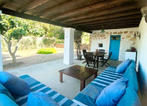 a patio with a blue couch and a table at Can Pep Frit in Ibiza Town